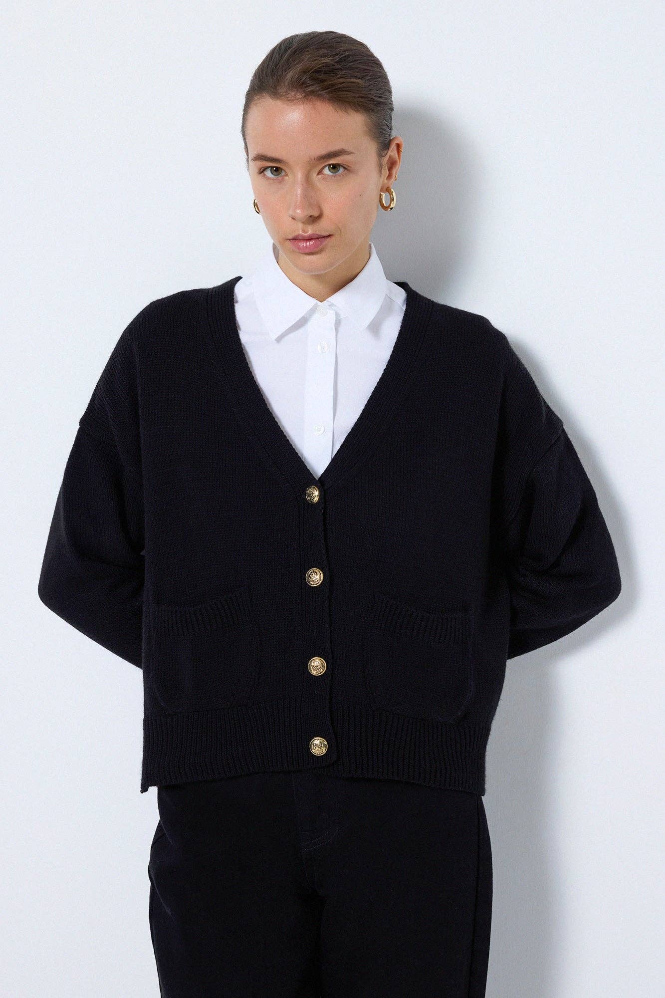 A KNIT CARDIGAN WITH BUTTON POCKET DETAILS